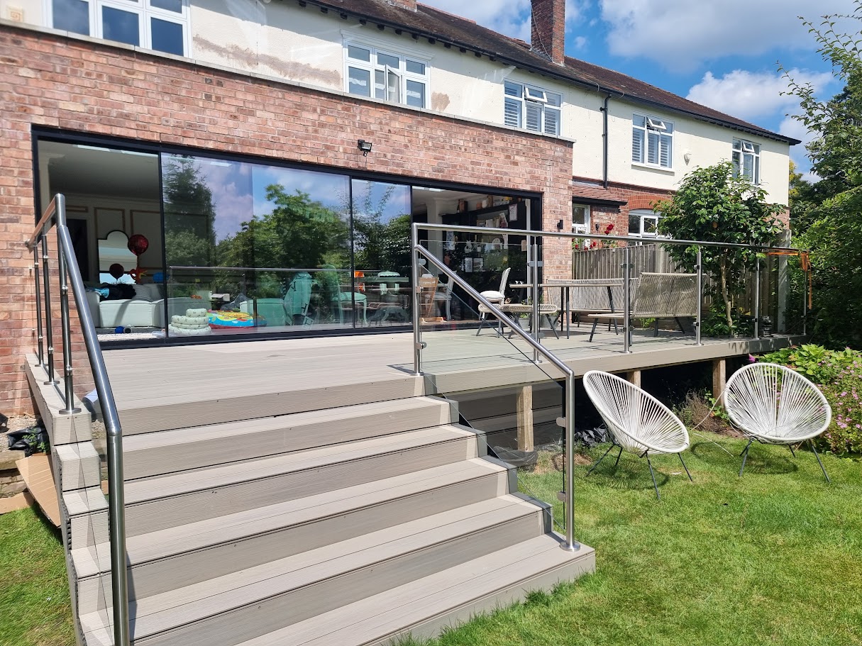 A stainless post glass balustrade on a Hale garden deck — Manchester Balustrades installation