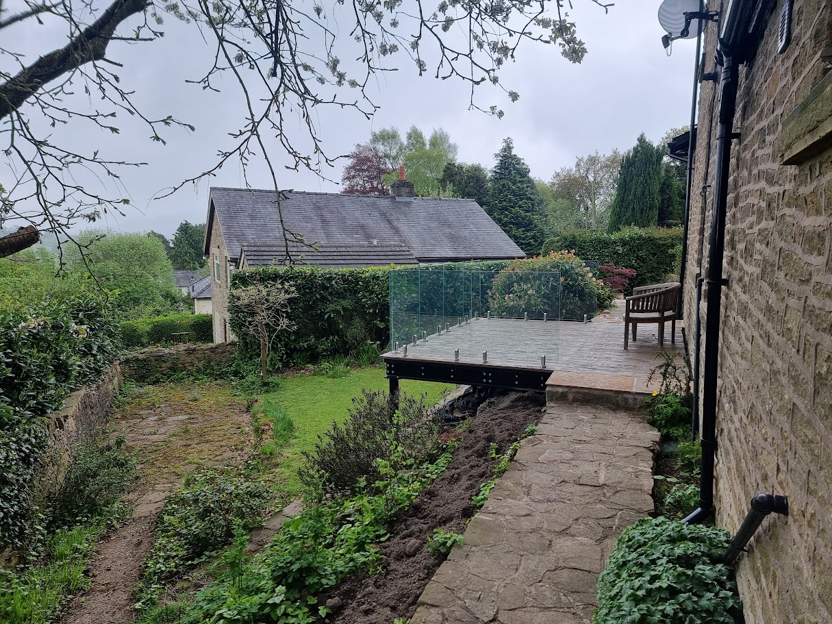 A stand-off glass balustrade on a raised deck in Whaley Bridge — further view of the completed installation