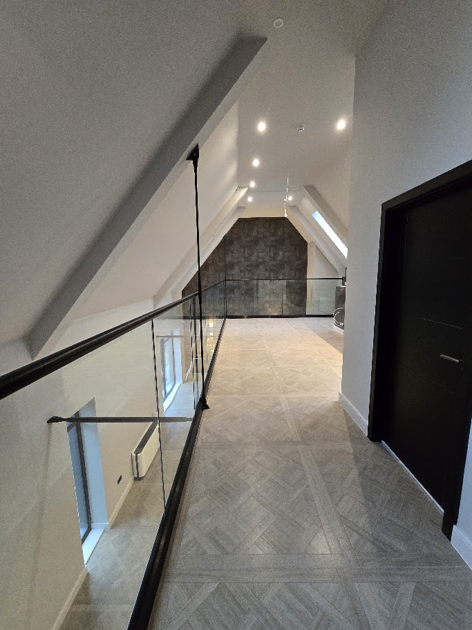 Frameless glass mezzanine in a vaulted home — further view of the completed installation