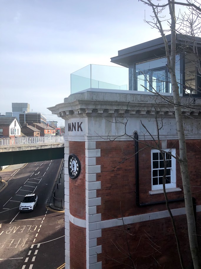 A rooftop terrace above a converted bank — further view of the completed installation