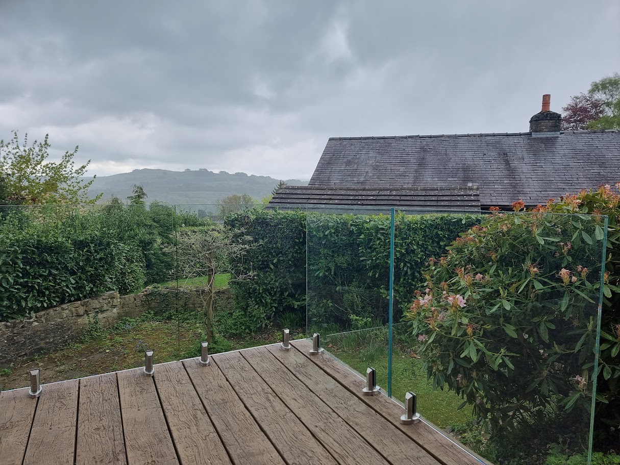 A stand-off glass balustrade on a raised deck in Whaley Bridge — further view of the completed installation