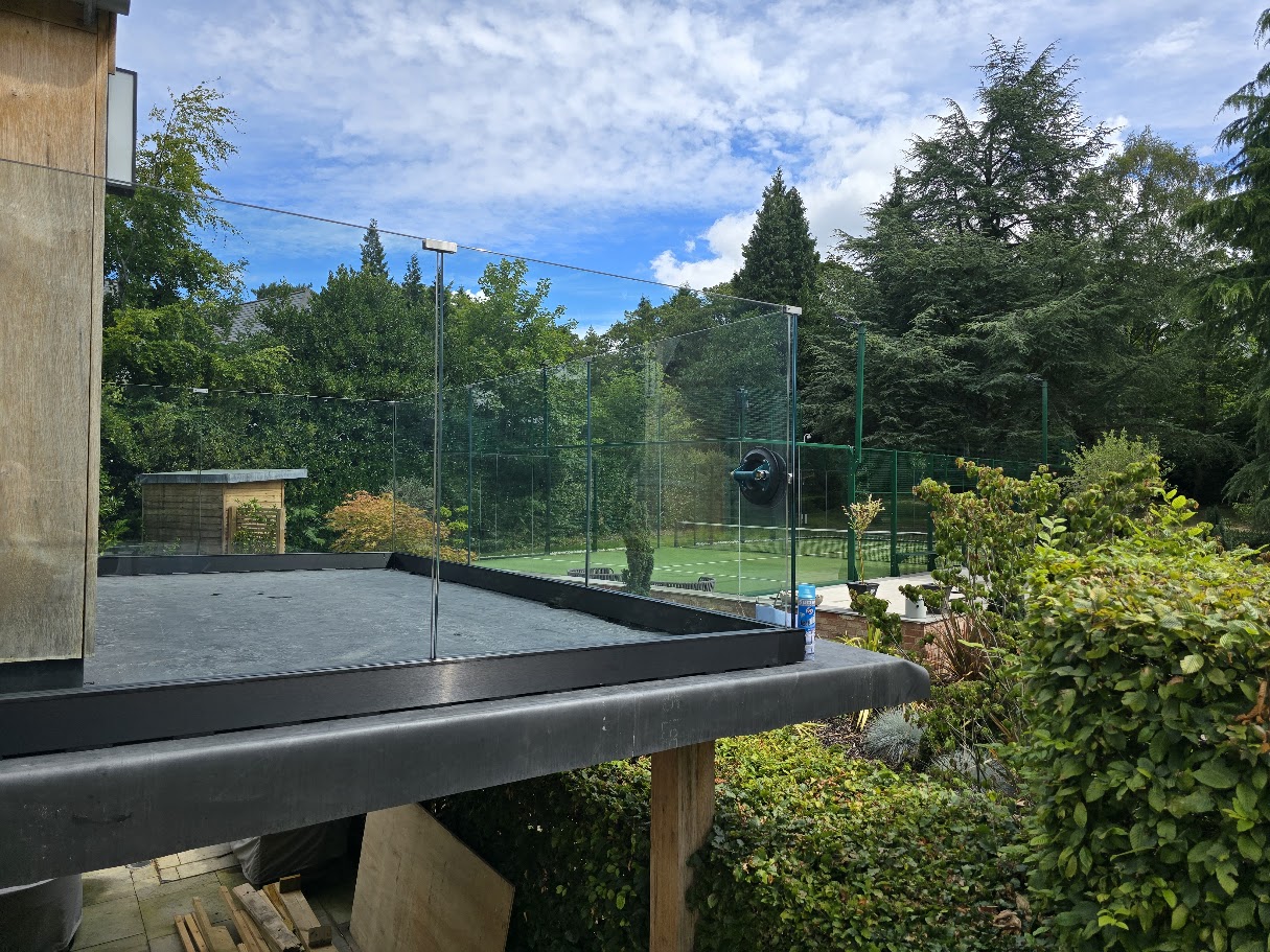 Frameless glass balustrade on a country house roof terrace — further view of the completed installation