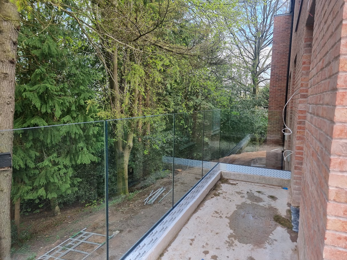 Frameless glass balconies at a contemporary Prestbury home — further view of the completed installation