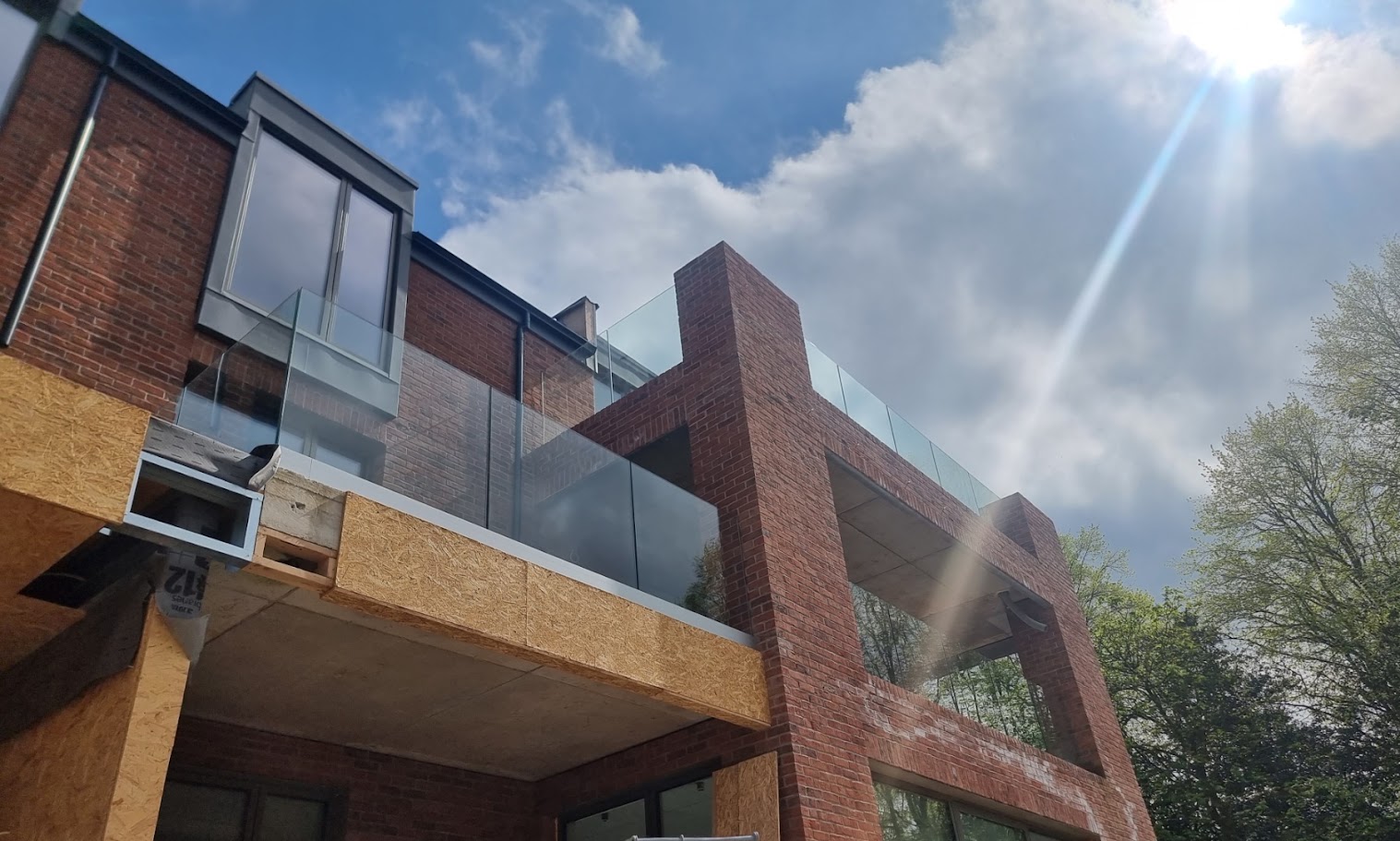 Frameless glass balconies at a contemporary Prestbury home — further view of the completed installation