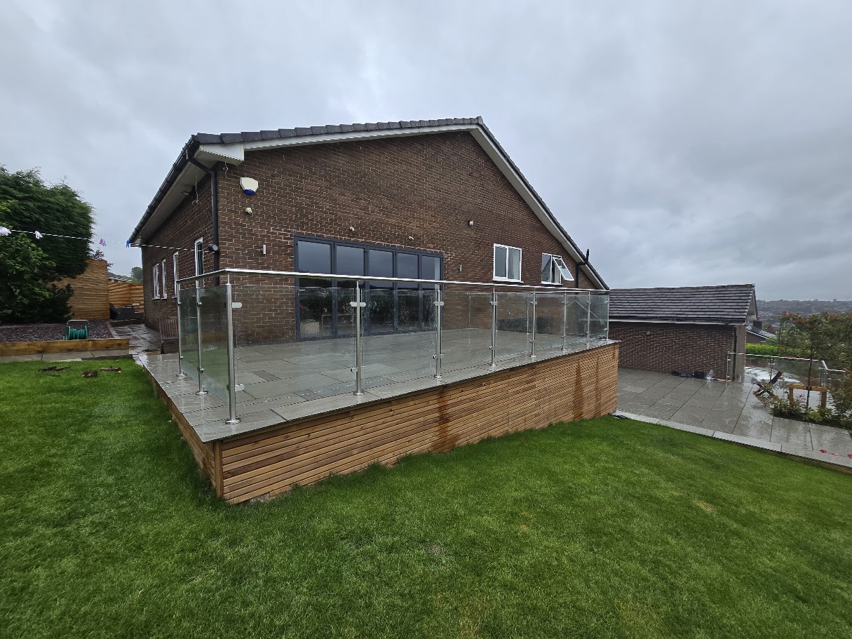 Stainless steel post and glass balustrade on a raised garden terrace — Manchester Balustrades installation