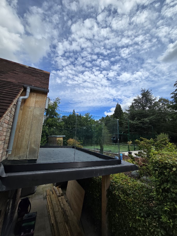 Frameless glass balustrade on a country house roof terrace — further view of the completed installation