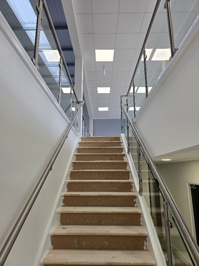 Stainless steel post and glass mezzanine balustrade — further view of the completed installation