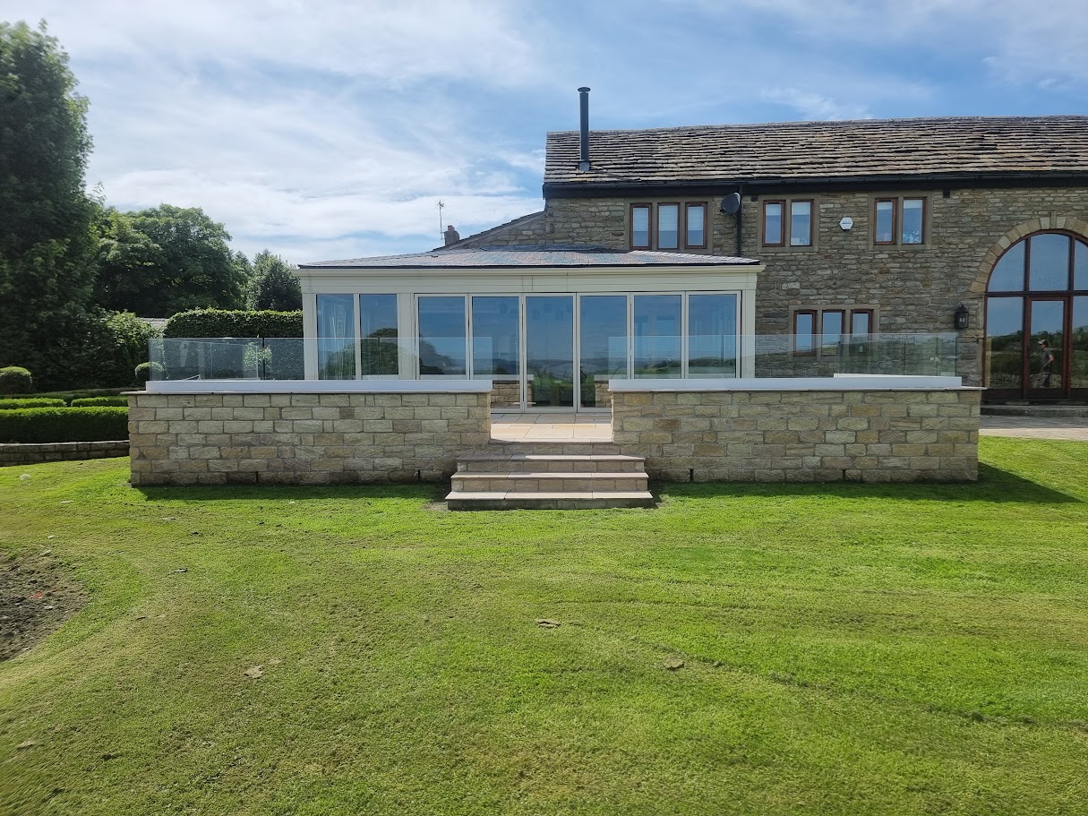 Frameless glass on a stone-walled terrace in Lymm — Manchester Balustrades installation
