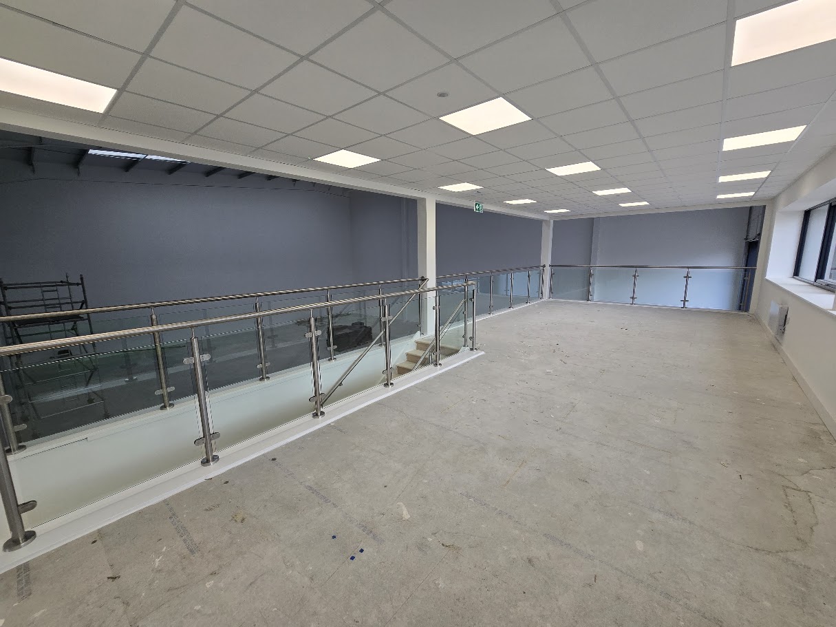 Stainless steel post and glass mezzanine balustrade — further view of the completed installation