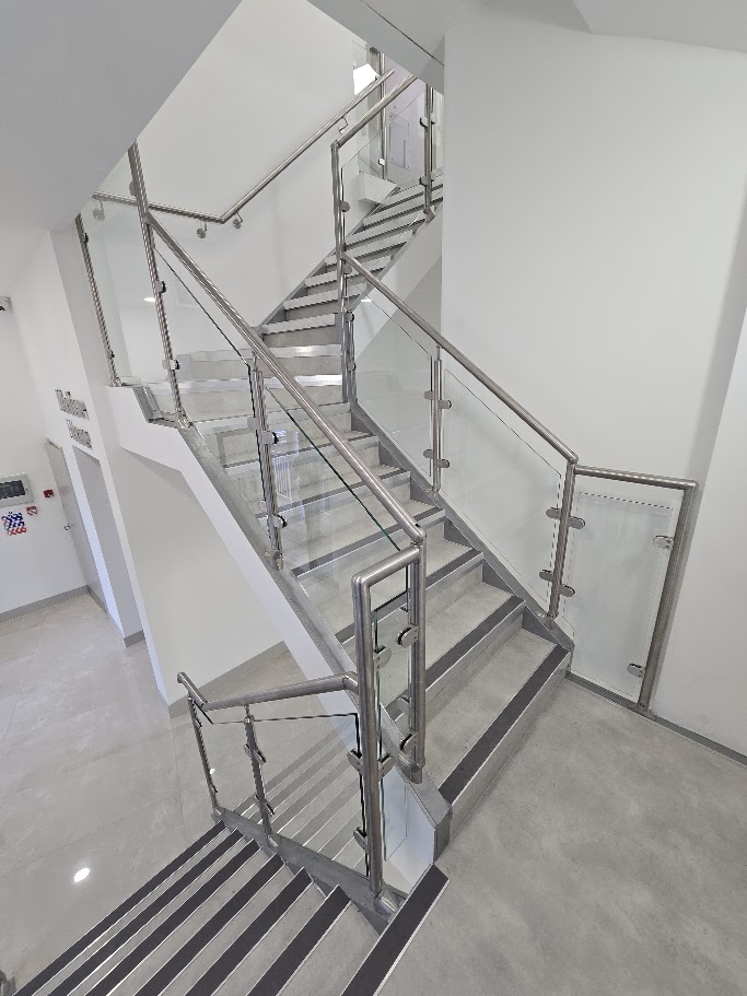 A post-and-glass commercial staircase at Madison House, Manchester — further view of the completed installation