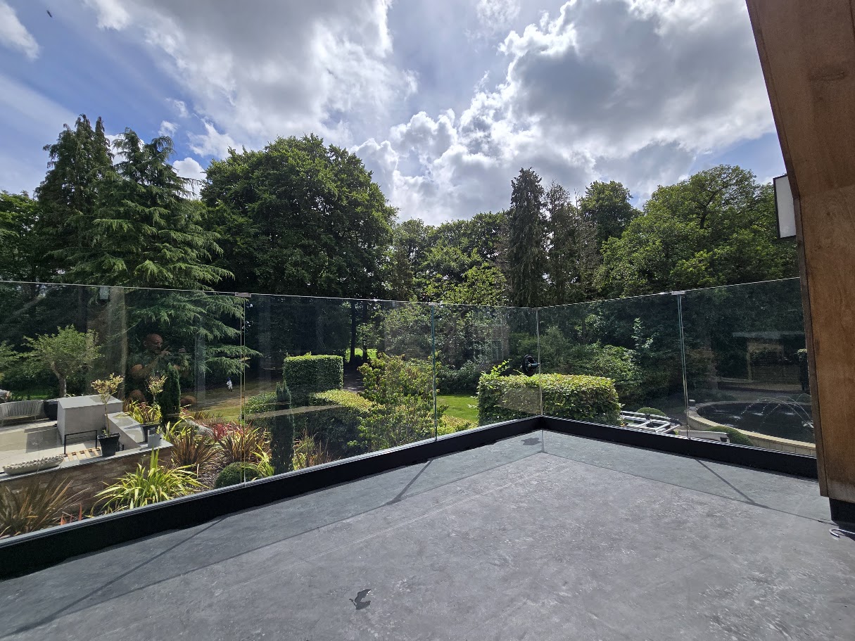 Frameless glass balustrade on a country house roof terrace — further view of the completed installation