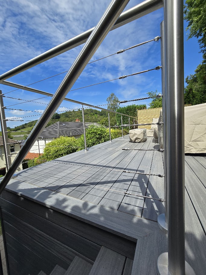 Stainless steel wire rope balustrade on a raised garden deck — further view of the completed installation