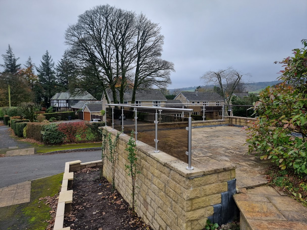 Bronze glass balustrades on stone terraces in Buxton — further view of the completed installation