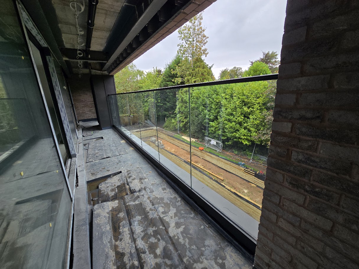 Frameless glass balcony on a new-build home — further view of the completed installation