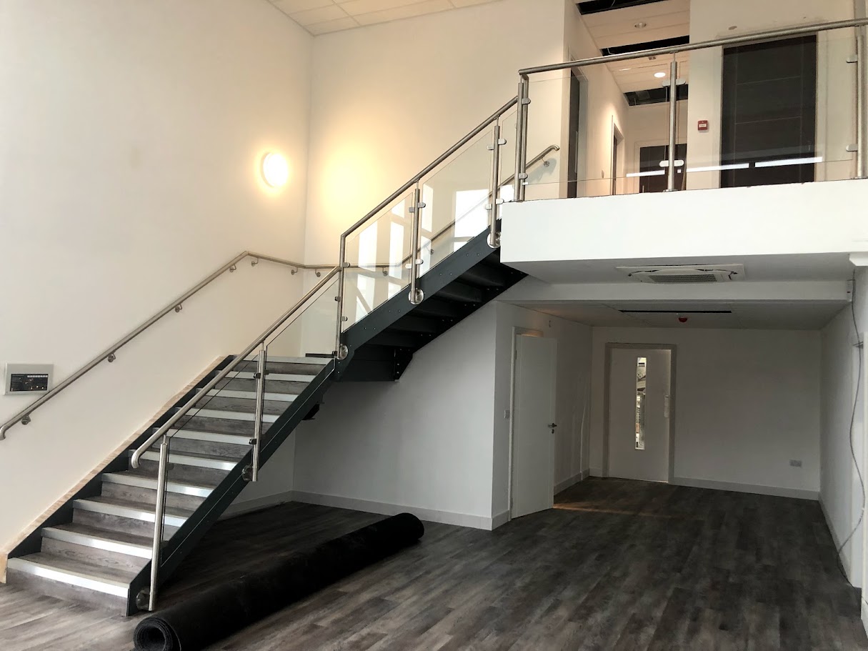 Glass balustrades for a commercial stair and landing — Manchester Balustrades installation