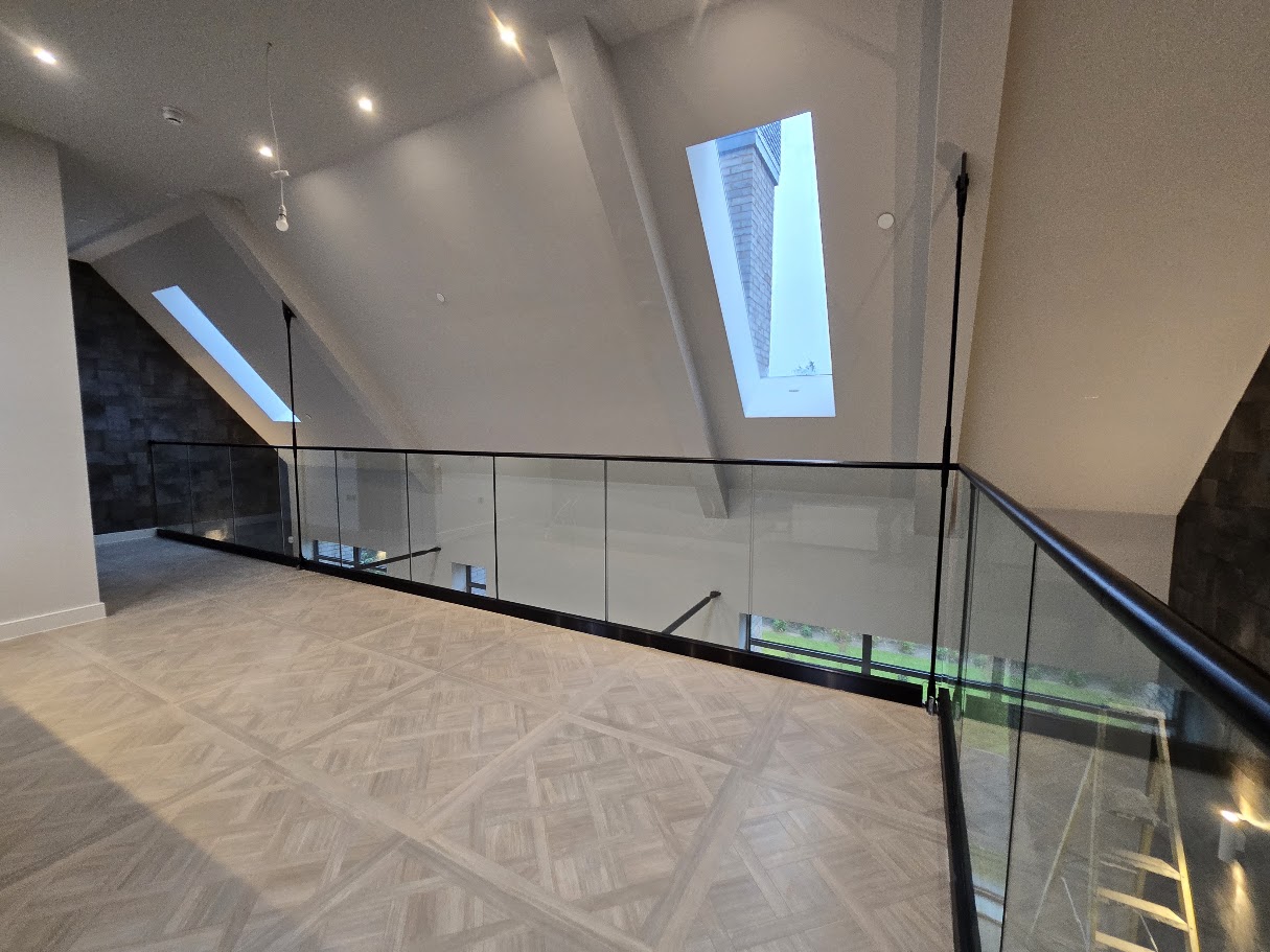 Frameless glass mezzanine in a vaulted home — further view of the completed installation