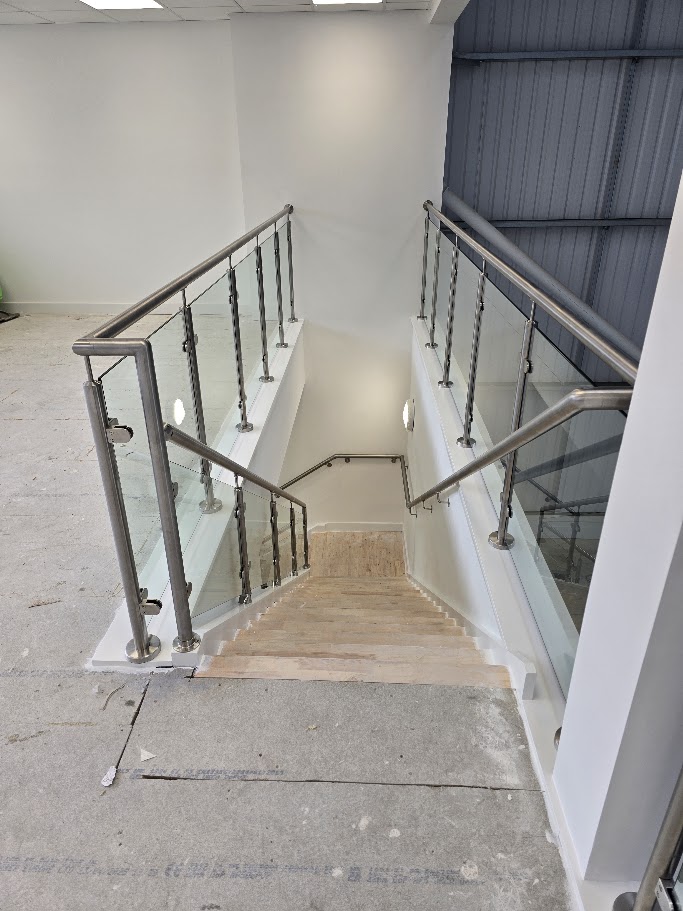 Stainless steel post and glass mezzanine balustrade — further view of the completed installation