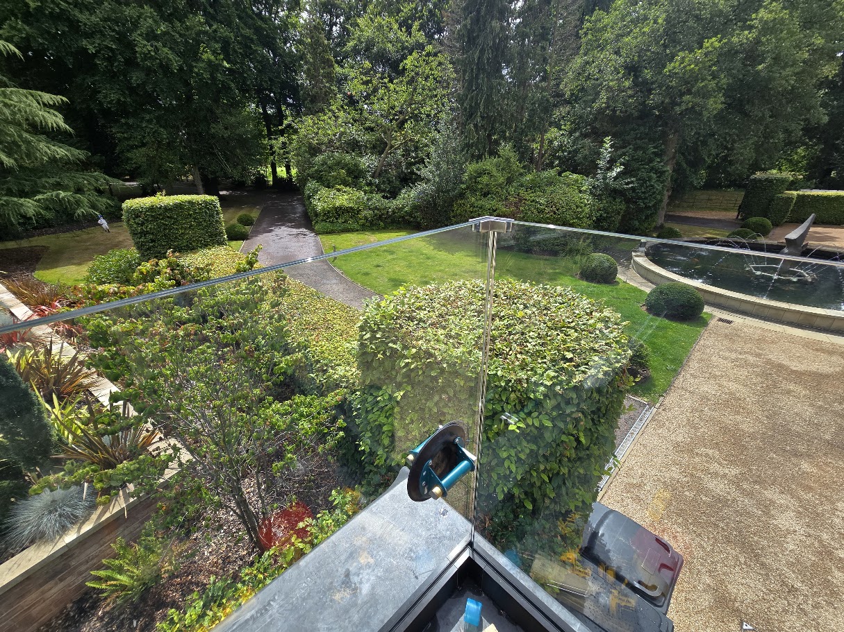 Frameless glass balustrade on a country house roof terrace — further view of the completed installation
