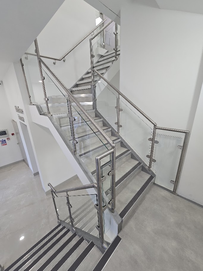 A post-and-glass commercial staircase at Madison House, Manchester — Manchester Balustrades installation