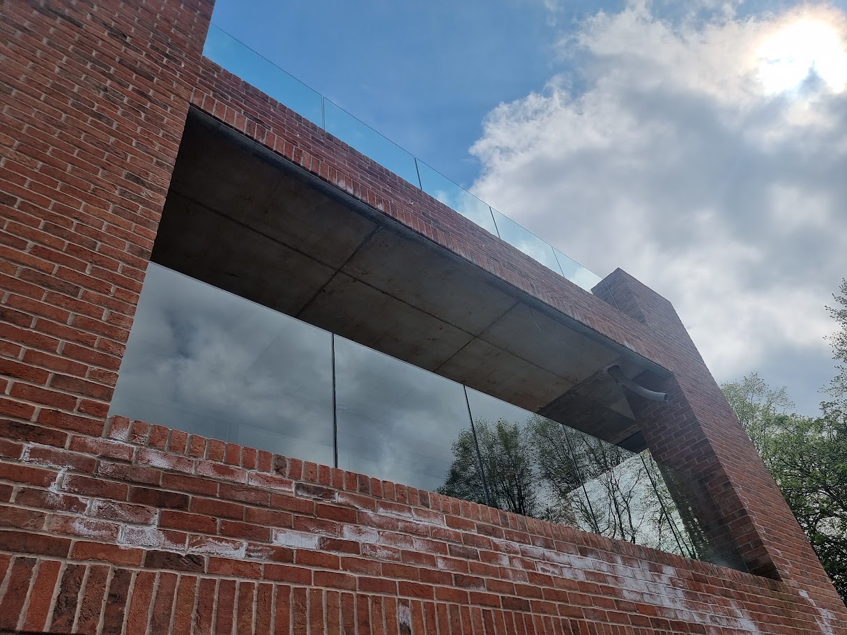 Frameless glass balconies at a contemporary Prestbury home — further view of the completed installation