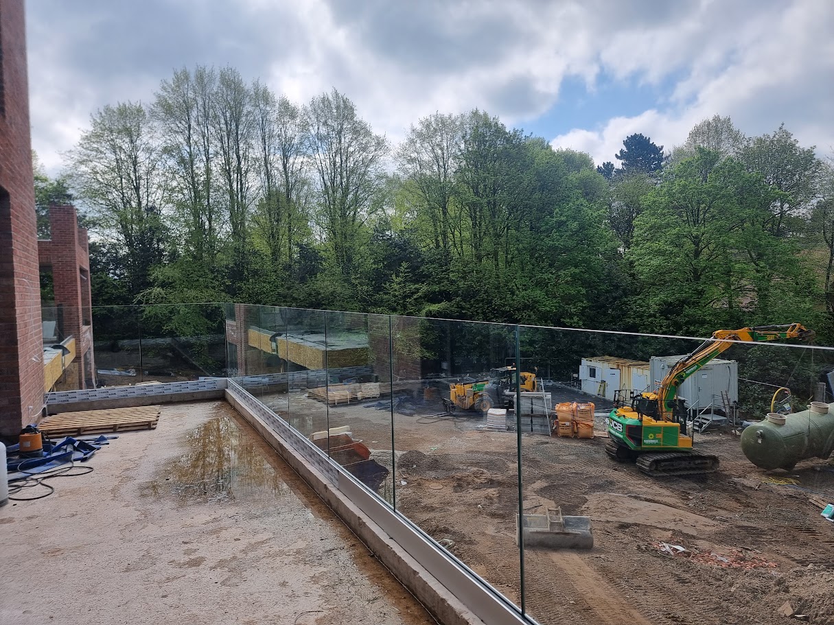 Frameless glass balconies at a contemporary Prestbury home — further view of the completed installation