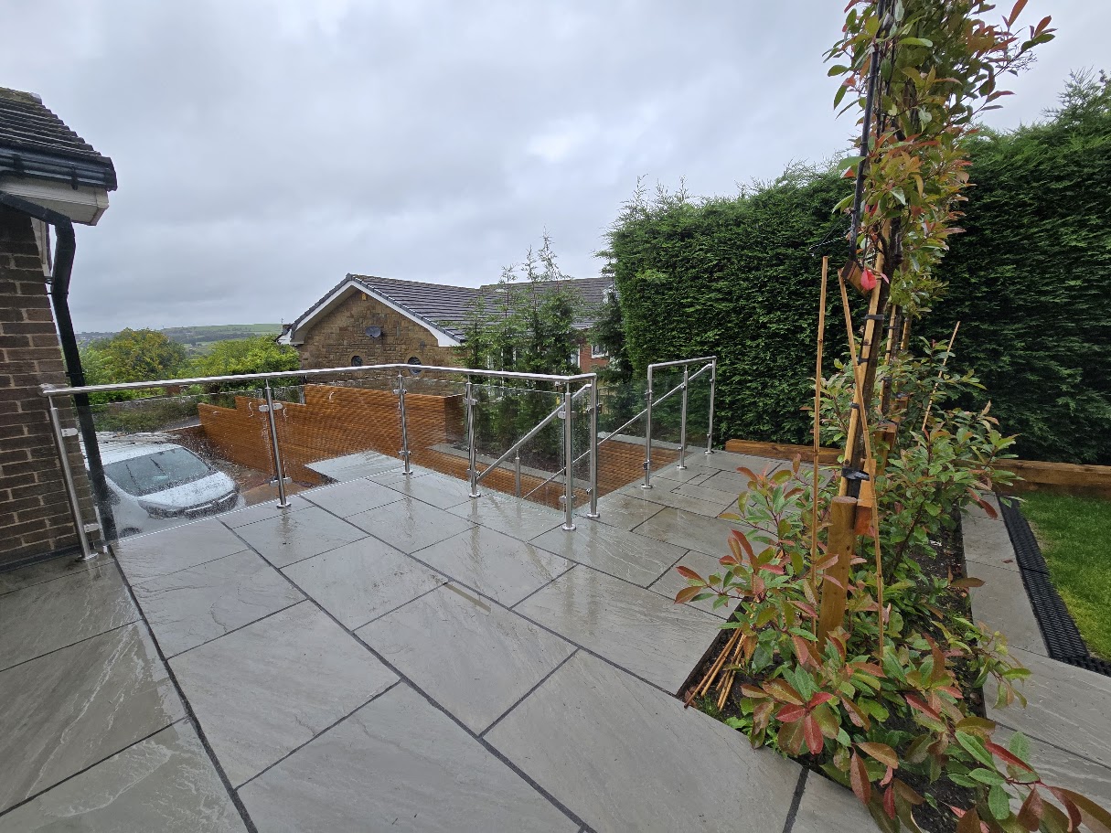 Stainless steel post and glass balustrade on a raised garden terrace — further view of the completed installation