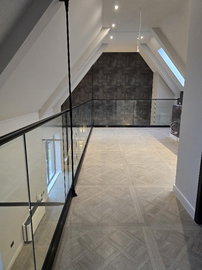 Frameless glass mezzanine in a vaulted home — further view of the completed installation