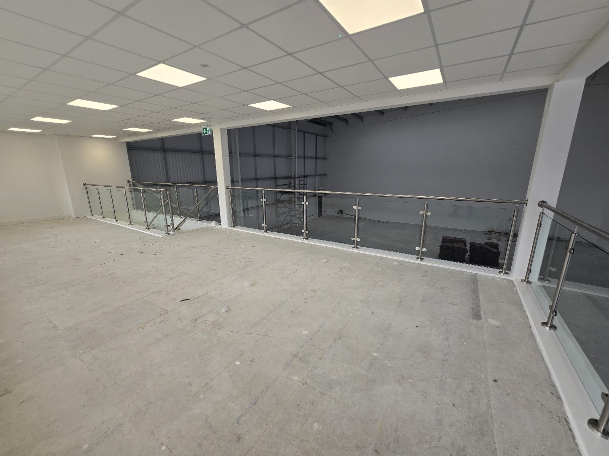 Stainless steel post and glass mezzanine balustrade — further view of the completed installation