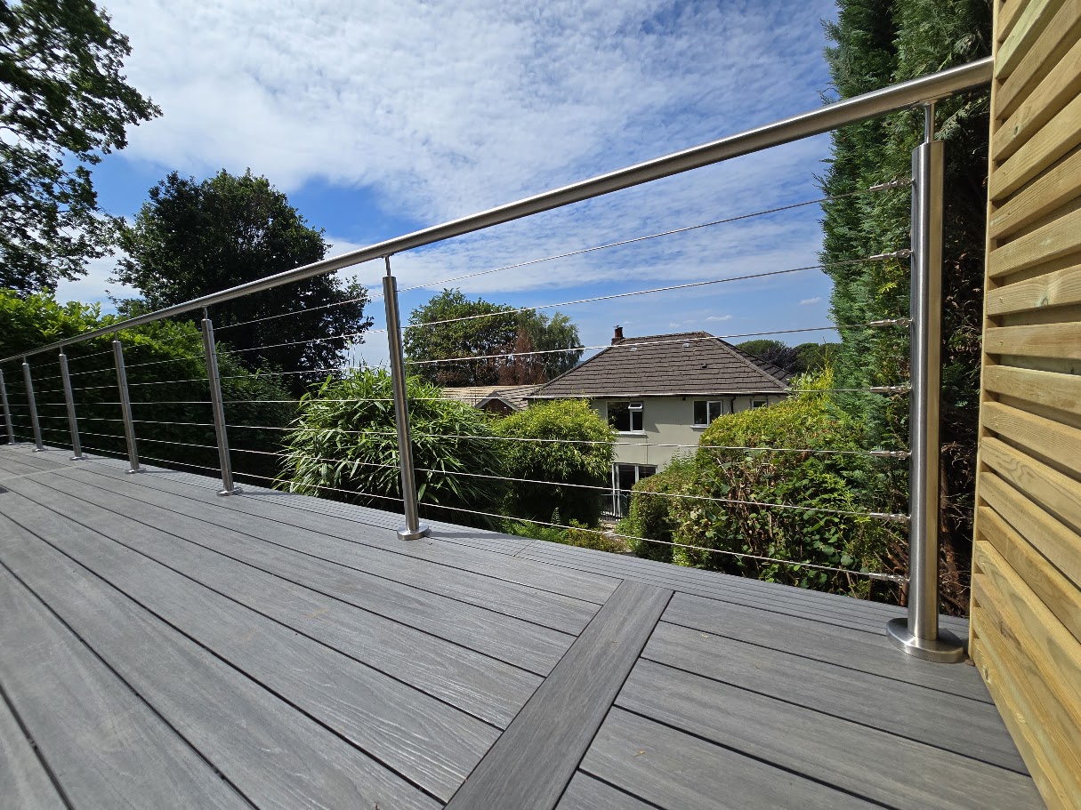 Stainless steel wire rope balustrade on a raised garden deck — Manchester Balustrades installation