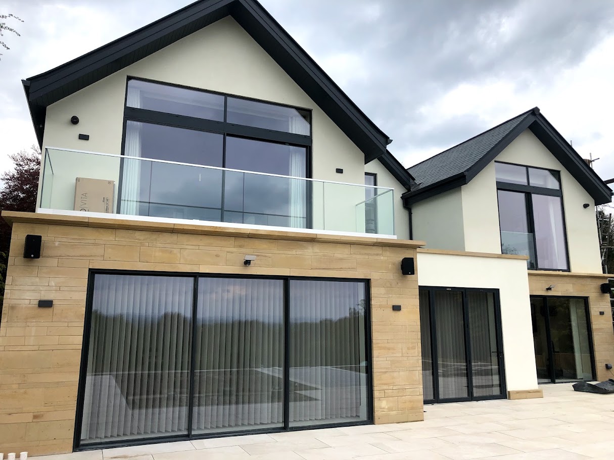A frameless balcony on a Mottram St Andrew new build — Manchester Balustrades installation