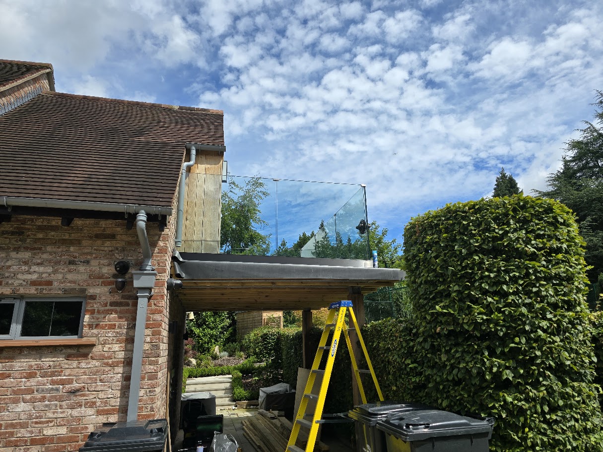 Frameless glass balustrade on a country house roof terrace — further view of the completed installation